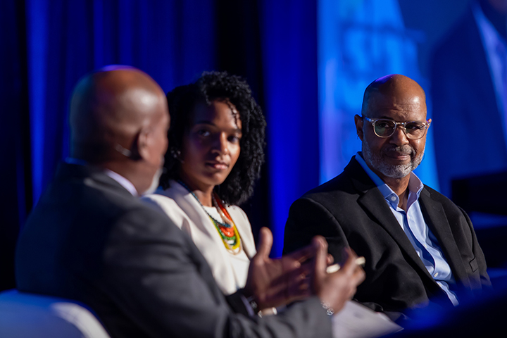 PMDLI facilitator Juan Johnson on stage with Dr. Brooke Dennard Rosser and WKAR general manager Shawn Turner