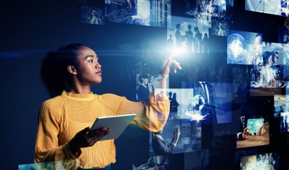 Image of young woman with a tablet and multiple screens