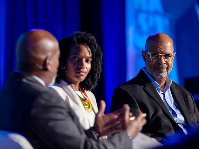 Photo of Shawn Turner, Dr Brook Dennard Rosser, and Juan Johnson on stage having a discussion